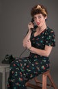Pinup Girl in Flowered Outfit on The Phone Looks Surprised Royalty Free Stock Photo