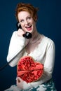 Pinup girl holding heart-shaped box of chocolates Royalty Free Stock Photo