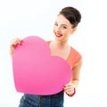 Pinup girl holding pink heart and happy smiling. Retro portrait of young cheerful woman in pin-up style Royalty Free Stock Photo