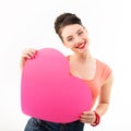 Pinup girl holding pink heart and happy smiling. Retro portrait of young cheerful woman in pin-up style Royalty Free Stock Photo