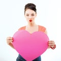 Pinup girl holding pink heart and happy smiling. Retro portrait of young cheerful woman in pin-up style Royalty Free Stock Photo