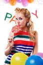 Pinup girl with lollipop, baloons and party word