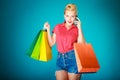 Pinup girl with shopping bags calling on phone Royalty Free Stock Photo