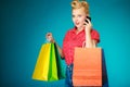 Pinup girl with shopping bags calling on phone Royalty Free Stock Photo