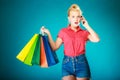 Pinup girl with shopping bags calling on phone Royalty Free Stock Photo