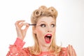 Pinup makeup. Funny woman gets eyebrow correction procedure. Young woman tweezing her eyebrows in beauty saloon. Young Royalty Free Stock Photo