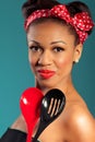 Pinup style housewife with kitchen utensils Royalty Free Stock Photo