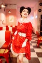 Pinup woman in retro cafe with checkerboard floor