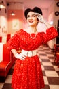 Pinup woman in retro cafe with checkerboard floor