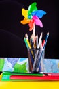 Pinwheel and pencils pot on stacked books, school supplies on white Royalty Free Stock Photo