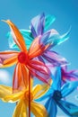 Pinwheels spinning in the wind, set against a bright blue sky with fluffy white clouds Royalty Free Stock Photo