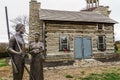 Pioneer Family Bronze Sculpture and Historic Cabin at Monument Park in Hamilton, Ohio. Royalty Free Stock Photo