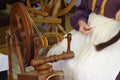 Vintage wooden spinning wheel in use