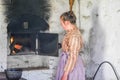 Pioneer Woman Looking inside Bread Oven