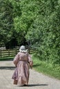 Pioneer Woman Walking Down Road