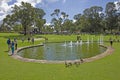 People and wild ducks around pool and fountains of Pioneer Women`s Memorial at King`s Park & Botanic Garden in Perth, Australia. Royalty Free Stock Photo