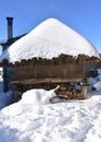 Ancient snowy wooden granary with thatched roof. Famous Piornedo mountain village, Ancares, Lugo, Galicia, Spain. Royalty Free Stock Photo