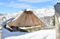 Famous Piornedo mountain village after a snowfall with ancient round Palloza stone houses with thatched roofs. Lugo, Spain. Royalty Free Stock Photo