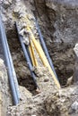 Pipe and cables in the soil after digging. Royalty Free Stock Photo