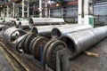 Pipe factory production line with steel tubular pipes on floor, metalwork heavy industry Royalty Free Stock Photo