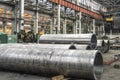 Pipe factory production line with steel tubular pipes on floor, metalwork heavy industry Royalty Free Stock Photo