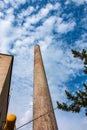 The pipe of a gas boiler house against the blue sky. No smoke comes out of the chimney. Energy crisis