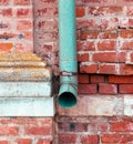 Pipe on an old red brick wall. Architectural background Royalty Free Stock Photo