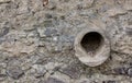Pipe in old stone wall Royalty Free Stock Photo