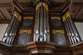 Pipe organ case facade from dark wood with golden decorations in the St. Mary`s Church of Gudow, a village in Schleswig-Holstein, Royalty Free Stock Photo