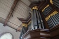 Pipe organ case facade in dark wood with golden decorations in St. Mary`s Church of the village Gudow, Schleswig-Holstein, German Royalty Free Stock Photo