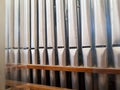 Pipe organ frontal shot, small silver pipes front row. Pipe organ and sacral christian liturgic music concept. Old vintage organ