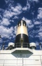 Pipe on the ship. White ship with a black chimney against the sk Royalty Free Stock Photo