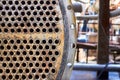 Pipe tube sheet or plate of heat exchanger or boiler part with flange closeup corrosion texture over out of focus