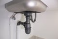 Water drain pipe under kitchen sink and faucet. Royalty Free Stock Photo