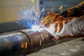 Pipe welding. The connection of the pipe with a clamp. Welder performs welding work semi-automatic electric arc welding Royalty Free Stock Photo