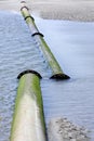 Pipeline on beach, broken connection. Royalty Free Stock Photo