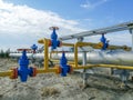 Pipeline collector of gas wells on the background of the drilling rig.