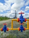 Pipeline collector of gas wells on the background of the drilling rig.