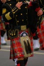 Piper in plaid kilt and black tunic Royalty Free Stock Photo