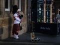 A piper playing bagpipes in Edinburgh`s street, Scotland Royalty Free Stock Photo