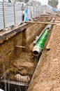 Pipes with heat isolation lieing in the trench. Royalty Free Stock Photo