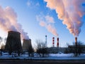 Pipes of the heating plant, a strong emission of steam. Winter, snow. Concept of ecology, greenhouse gases and environmental Royalty Free Stock Photo