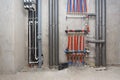 Pipes of heating and water supply system on the background of a concrete wall
