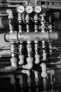 Pipes and levers controls central heating system of house in black and white Royalty Free Stock Photo