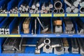 pipes, metal pieces and various metal parts for a CNC machine standing on a shelf Royalty Free Stock Photo