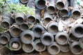Pipes are stacked in a place that looks old and dirty. PVC pipes used for irrigation purposes abandoned