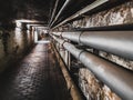 Pipes on underground maintenance tunnel wall