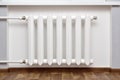 Pipes and a white heating radiator heat the room Royalty Free Stock Photo