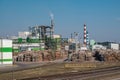 Pipes of woodworking enterprise plant sawmill near river. Air pollution concept. Industrial landscape environmental pollution