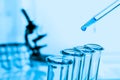 Pipette adding fluid to one of several test tubes Royalty Free Stock Photo